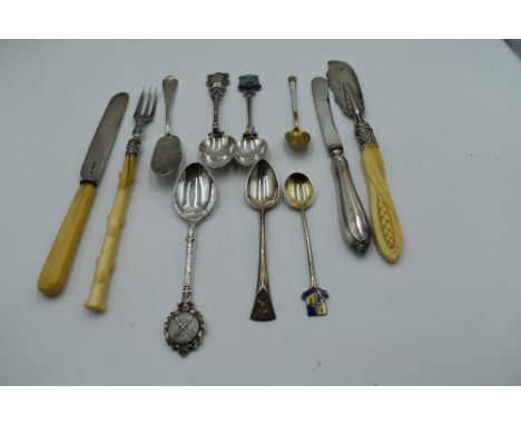 A selection of HM silver flatware including souvenir spoons, butter knives and pickle fork etc