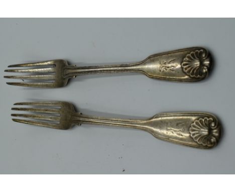 A pair of Georgian silver table forks having moulded scallop shell decoration to terminals and reverse of fork, London, date 