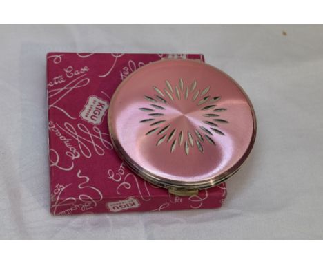 A 1960's silver powder compact by Kigu having cut decoration to pink ground, with original box, London 1964, Kigu Ltd
Conditi