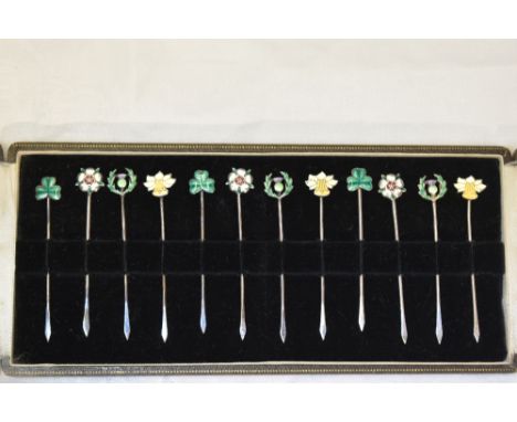 A cased set of twelve enamelled cocktail sticks stamped silver bearing Shamrocks, Daffodil, Thistle &amp; Rose to terminals
W