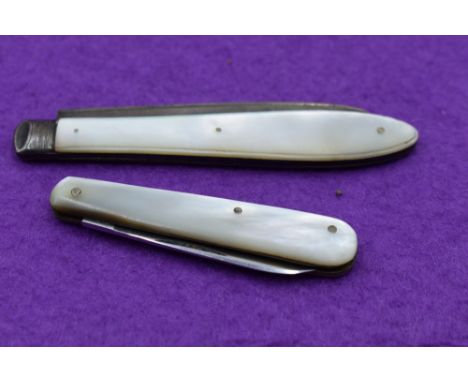 A Victorian folding fruit knife having a silver blade with engraved grape vine decoration and a mother of pearl handle bearin