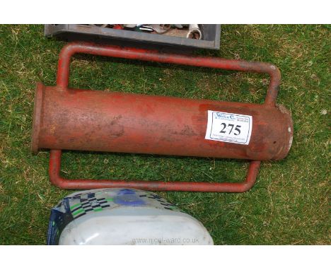 A manual post rammer.