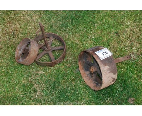 Three vintage engine trolley wheels.