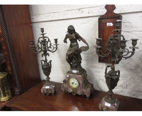 Large 19th Century French patinated spelter and rouge marble three piece clock garniture with figure and urn surmounts, the c