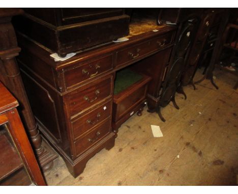 Reproduction mahogany twin pedestal desk with a leather inset top above nine drawers with brass handles and bracket feet