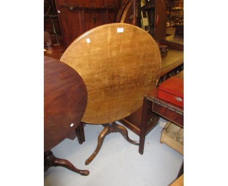 George III oak circular pedestal table, the tilt-top above a turned centre column and tripod base