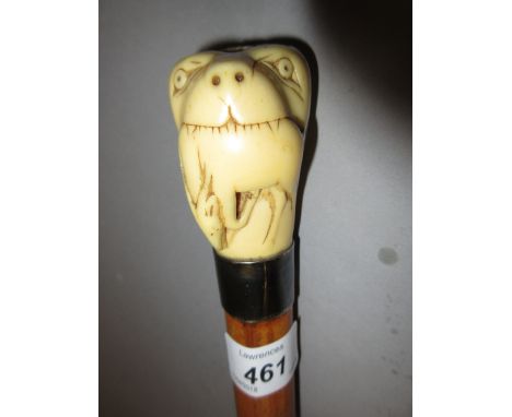 19th Century carved ivory handled walking stick, the handle carved in the form of a lion with an antelope in its mouth 