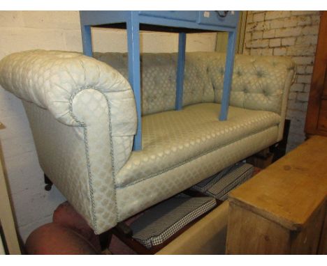 Early 20th Century button upholstered Chesterfield type sofa on square tapering mahogany supports with casters (at fault)