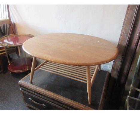 20th Century light ash Ercol oval coffee table with undertier on splay supports