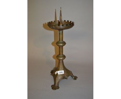 Brass pricket candlestick on a Gothic style tri-form base
