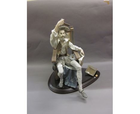 Large Lladro figure of a seated Don Quixote holding sword aloft (at fault - pieces of books included)