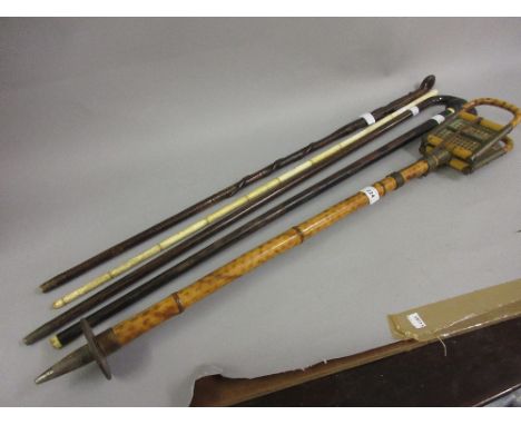 Bamboo shooting stick and a sectional bone walking cane (at fault) and three other walking canes