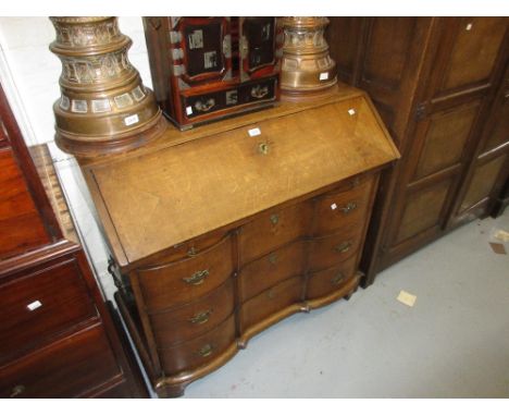 18th Century continental oak bureau, the fall front enclosing a fitted interior above three serpentine fronted drawers, raise