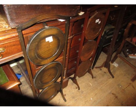 Two 1930's folding cake stands together with a three division stick stand