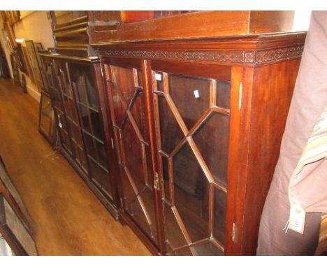 Edwardian mahogany dwarf bookcase with decorative frieze above two astragal glazed doors on bracket feet