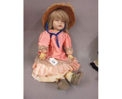 K. and R. bisque headed doll with moulded painted eyes on a jointed composition body, the head marked K. and R. 114 above the