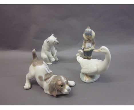 Lladro figure of a dog, another of a polar bear, Lladro figure of a child with a bear cub and a Nao figure of a duck