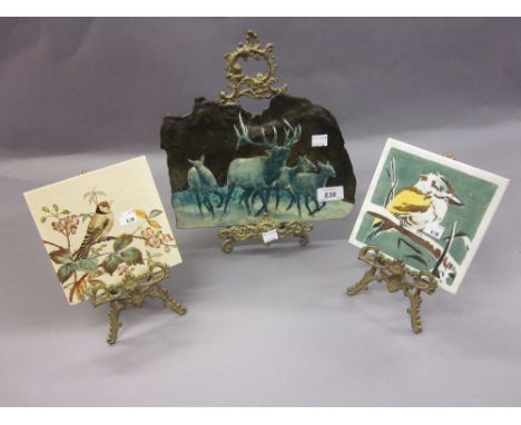 North American enamel decorated slate plaque depicting deer, a Minton tile decorated with a bird together with another tile, 