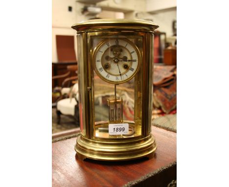 19th Century brass cased four glass library clock of oval form with an enamel dial, two train movement, mercury compensated p
