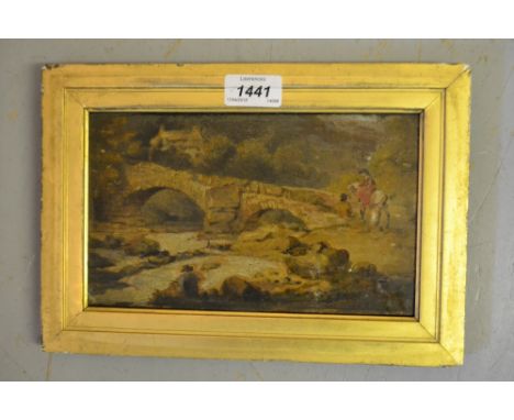 Small 19th Century oil on paper applied to panel, river scene with figures before a stone bridge, indistinctly signed, 5ins x