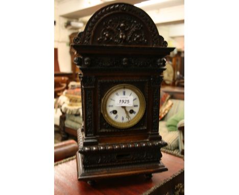 19th Century Continental carved walnut bracket clock, the architectural case with applied relief work of scrolls and mask hea