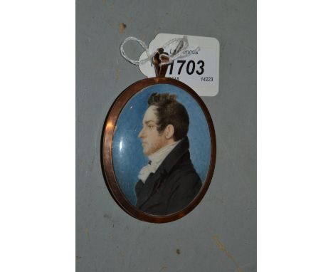 Early 19th Century watercolour, portrait miniature of a gentleman in profile wearing a black coat in an oval rose metal frame