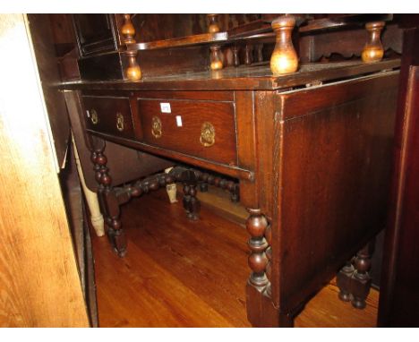 Reproduction oak drop-leaf side table with two drawers on bobbin turned supports and gate leg ends supporting the drop leaves