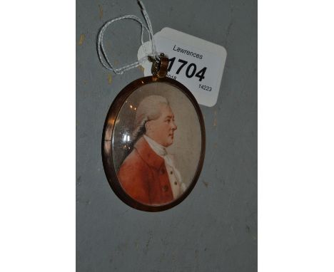 18th / 19th Century watercolour, portrait miniature on ivory of a gentleman wearing a red coat, mounted in an oval gilt metal