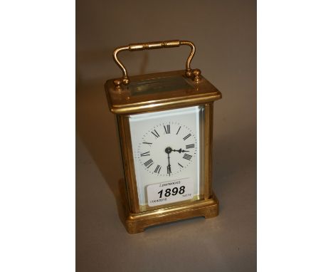 Small brass cased single train carriage clock with enamel dial and Roman numerals