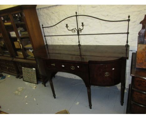 Regency mahogany semi bow front sideboard with a central drawer flanked by door and cellarette drawer, raised on turned taper