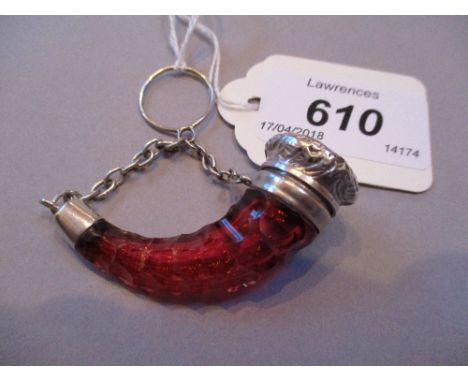 Unusual ruby glass cornucopia perfume bottle with ornate white metal mounts and attached chain, overall length 2ins excluding