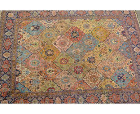 Tabriz carpet with an all-over tile and palmette design in shades of pale blue, ivory, beige, pink, yellow ochre and iron red