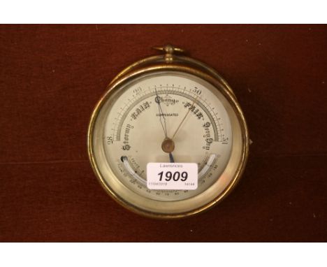 Brass cased circular barometer thermometer having silvered dial 