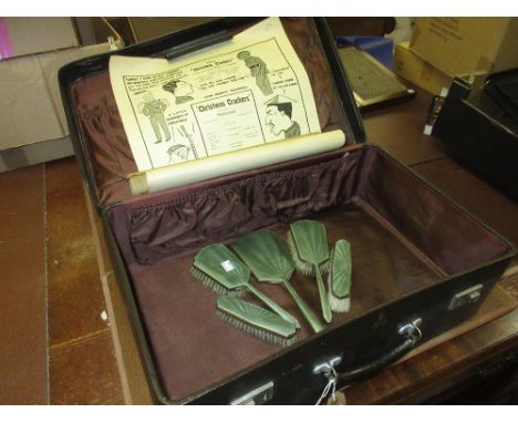 Silver plated and enamel five piece dressing table set in a simulated leather case with a rolled advertising bill for Christm