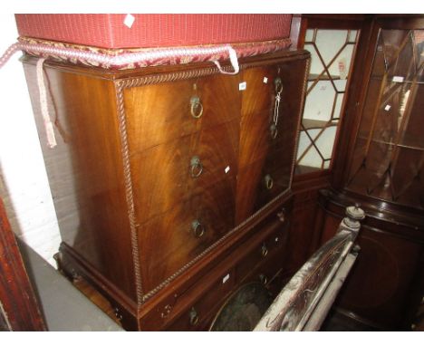 Early 20th Century mahogany chest with gadroon moulding surrounding three graduated drawers with brass ring handles and pierc