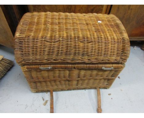 Wicker work car trunk with hinged cover, secured by leather straps