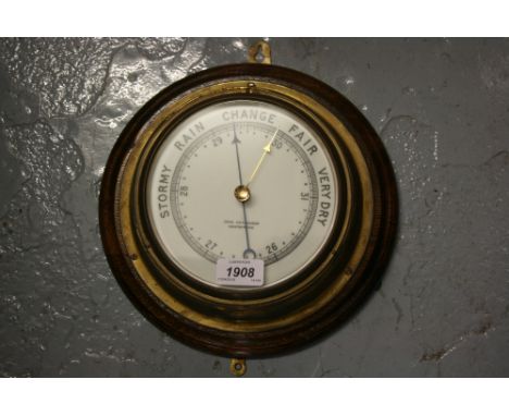 Ships brass cased circular barometer on oak plaque, inscribed John Hutchinson