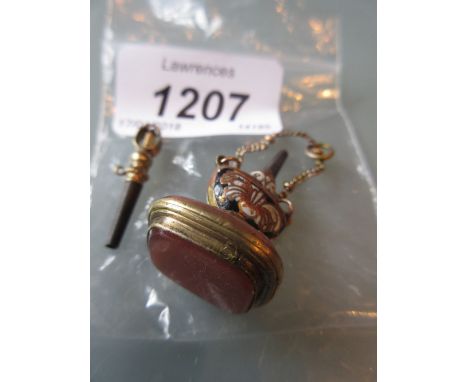 Two small gilt metal watch keys, one with enamel decoration