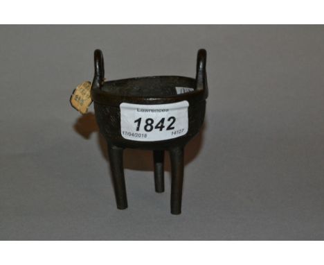 Small antique Chinese dark patinated bronze two handled censer raised on three supports (bearing paper label)