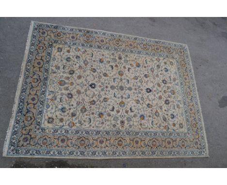 Tabriz carpet having all-over floral design with borders on a beige ground, 12ft x 8ft 7ins