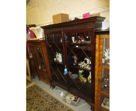 Late 19th or early 20th Century mahogany bookcase, the moulded dentil cornice above a relief work frieze and two astragal gla