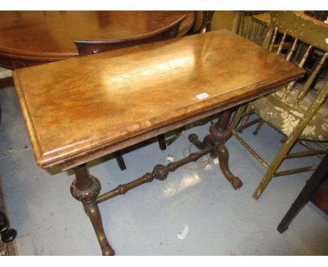 Victorian rectangular figured walnut fold-over card table on turned end supports with splay feet