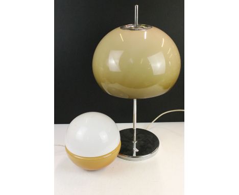 Vintage chrome and smoked glass table lamp having a globular shade mounted to a chrome base together with a two tone glass ta