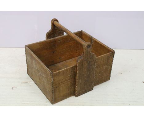 Wooden trug of square form with turned handle to top. Measures 31 x 39 x 30cm. 