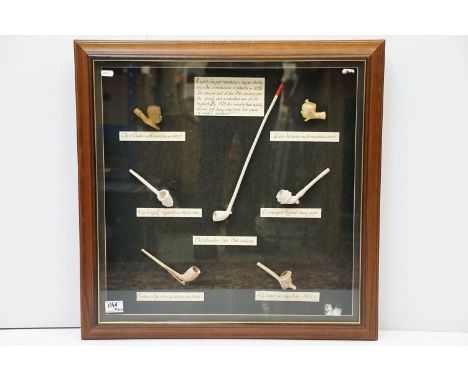Framed selection of clay pipes to include Chief Chaka and Queen Victoria meerschaum effect examples, King George V, churchwar