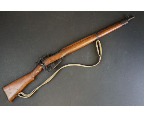 A Lee-Enfield (SMLE) No.4 MK.II (F) .303 bolt-action service rifle with adjustable sights, storage compartment to the brass b