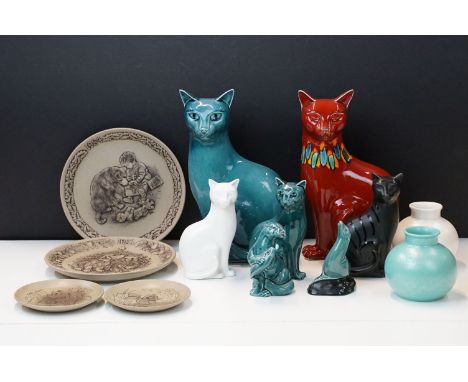 Selection of Poole pottery ceramics to include two large cats, one in red flambe glaze, otter and fish ornament, three smalle