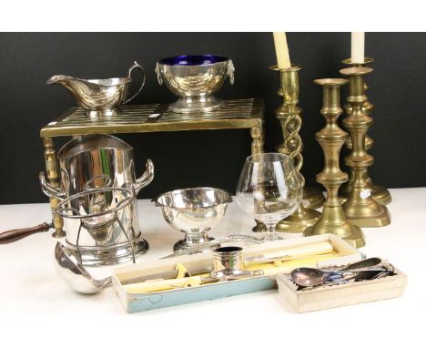 Assortment of metalware to include large brass fireside trivet, candlesticks, ladle, ink well, spoons, carving set, brandy gl