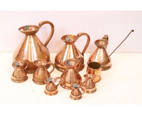 Collection of copper cider gallon flagons in graduating sizes 1/8 Gill, 1/4 Gill, 1/2 Gill, 1 Gill, 1/2 Pint, Pint, Quart, ha