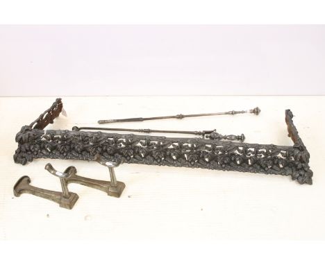 Cast iron fire fender having moulded and pierced foliate details together with a pair of fire dogs, poker, tongs and shovel. 